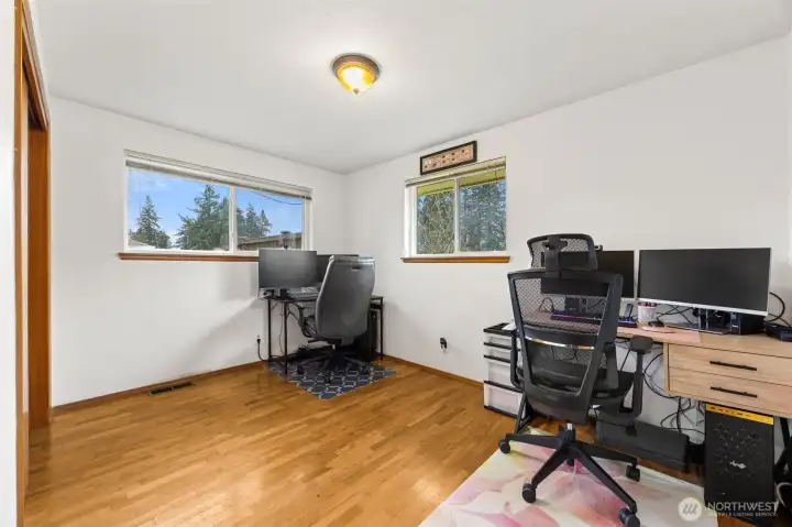Bedroom #2 is currently being used as an office space but offers nice natural lighting from two windows, hardwood floors + good sized closet.