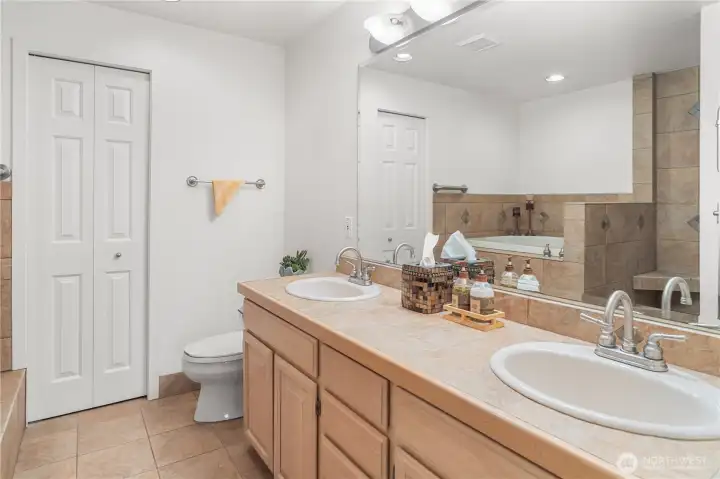 Primary Bedroom's Ensuite with dual vanity sings, japanese soaking tub and separate showers