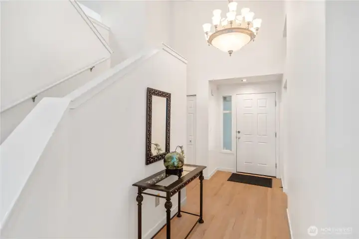 Wood Flooring and grand lighting in the entry