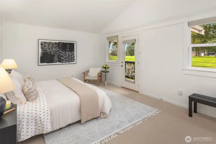 Relaxing retreat! Primary bedroom with deck overlooking the golf course.