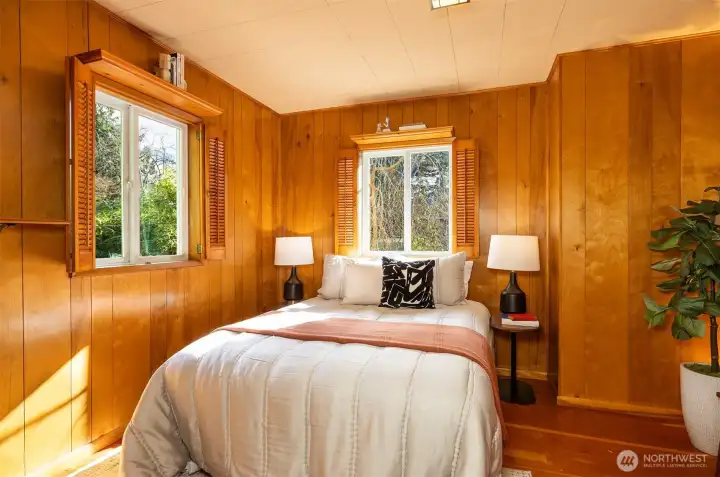 Second bedroom on the main floor has charming wood paneling.