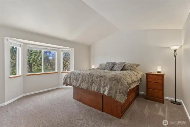 Large primary suite with elegant cathedral ceilings