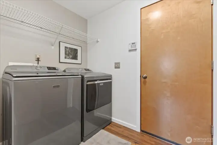 Laundry room with convenient overhead storage rack for added organization