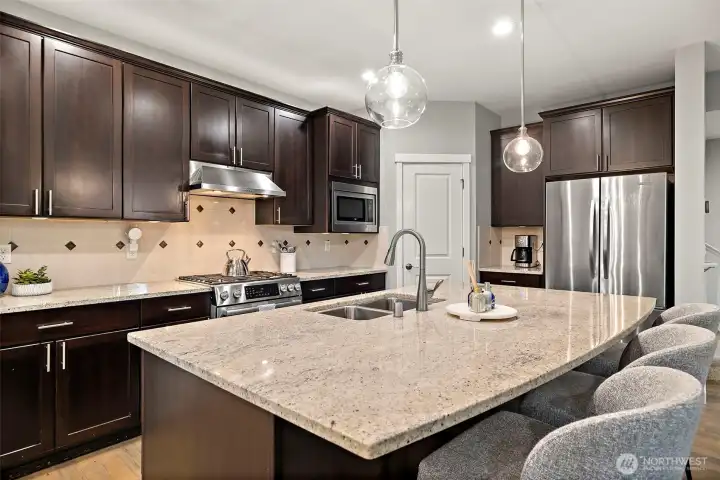 Quartz slab countertops, sliders inside cabinets for easy access