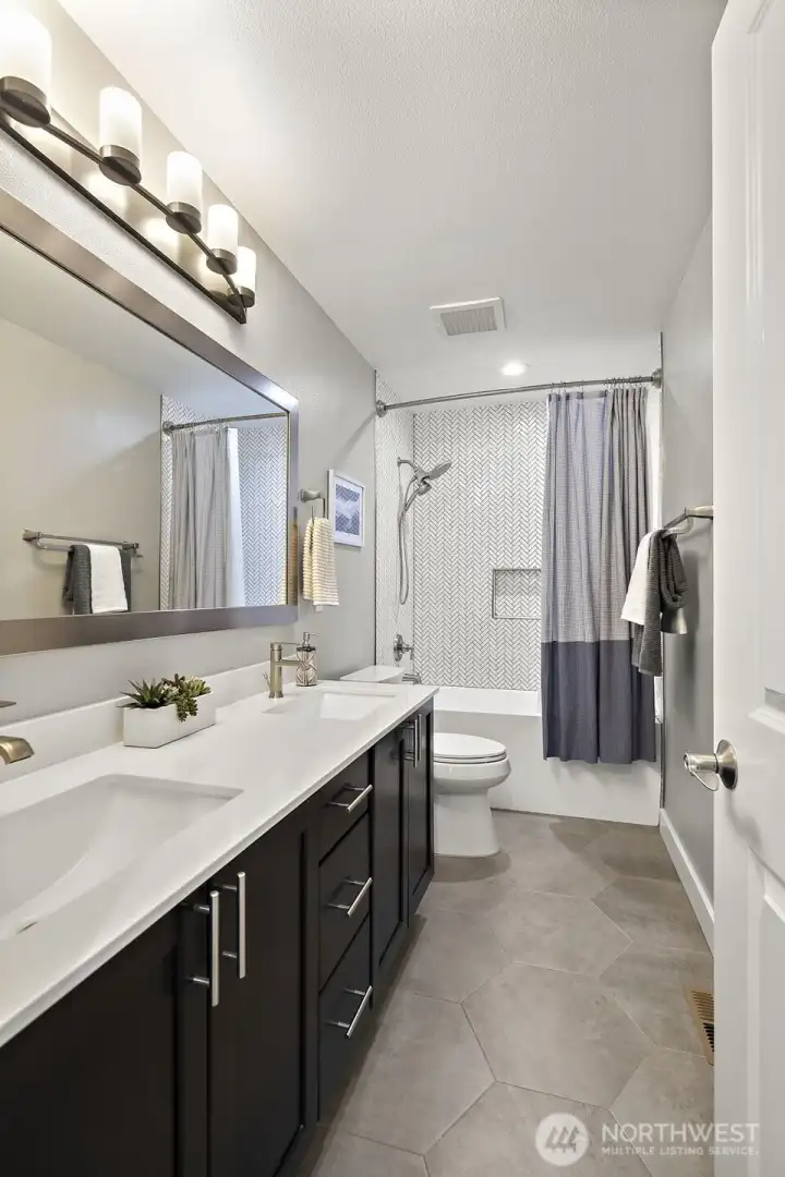 Totally Updated Guest Bath with full height tiles to the ceiling