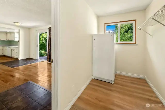 Storage area with a upright freezer.