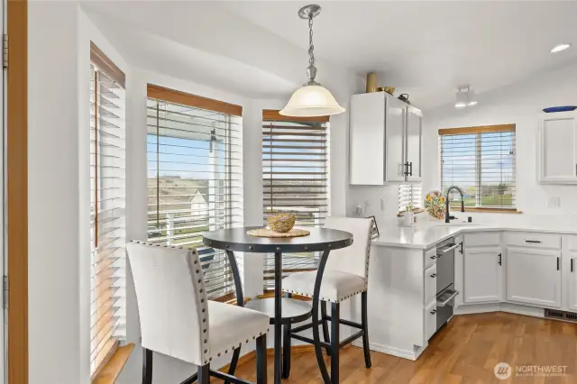 The kitchen's bay window is an ideal spot for a charming bistro table, offering a lovely view across the new deck.