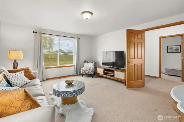 The bonus/media room with double doors is conveniently located off the entryway.