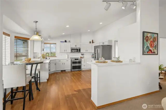 The refreshed white kitchen boasts sleek new quartz countertops.