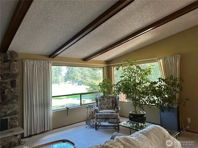 The corner windows overlook the golf course.