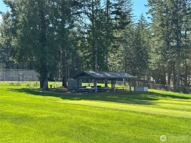 Picnic area next to the dog park, playground, tennis courts and sport court