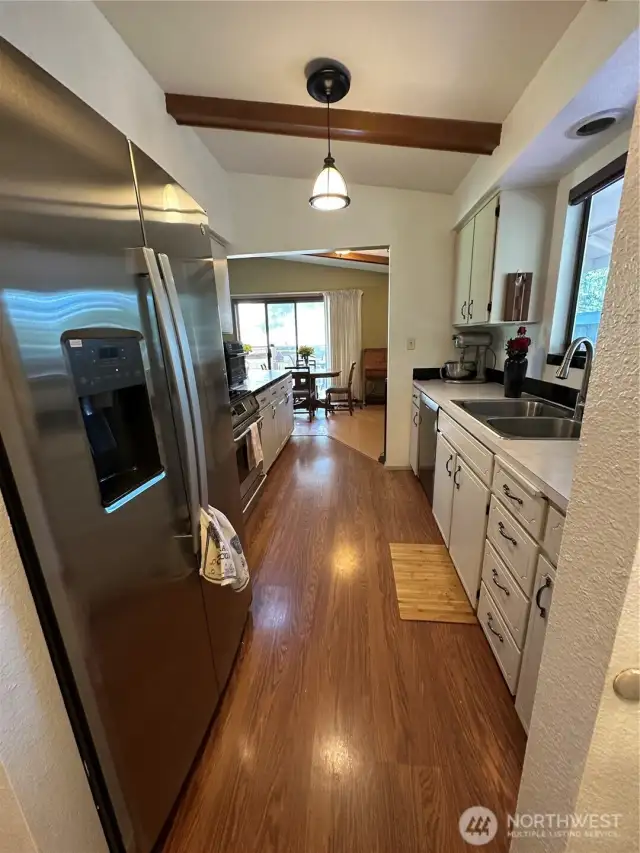 Galley kitchen with stainless steel appliance.