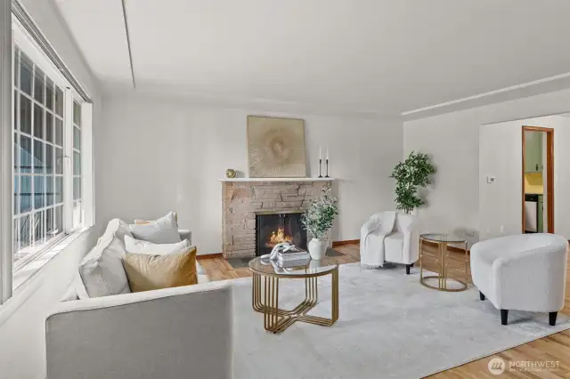 Relax by the fireplace in the living room with plenty of natural light.