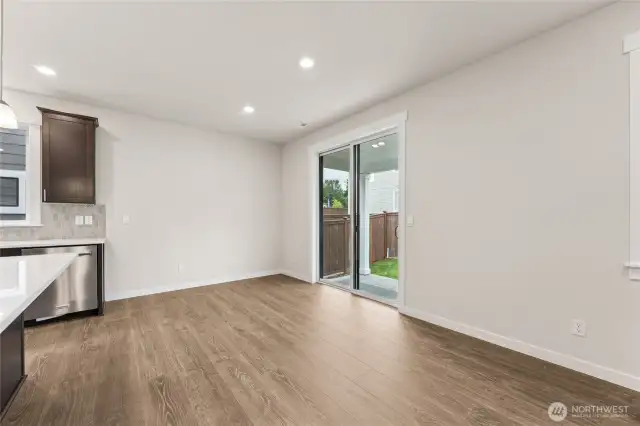 Dining room area off the kitchen and large center island. Actual home is under construction and materials, colors, and finishes will vary. See site agent for details.
