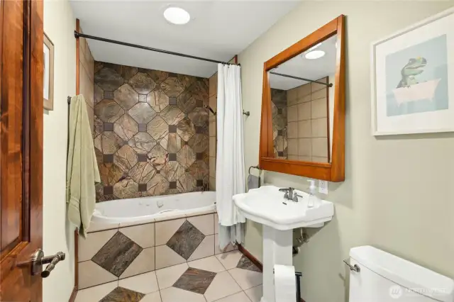 Full bath with jetted tub and ceramic tile