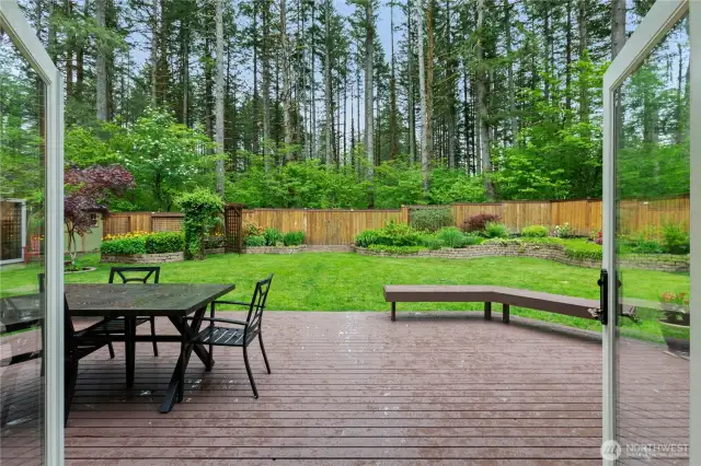 The view from the dining room. Notice the stone raised garden beds! The fence has a gate that opens to 80 acres of greenbelt and trails behind.