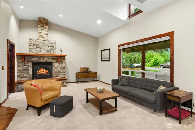 The great room boast a stone gas fireplace and vaulted ceilings