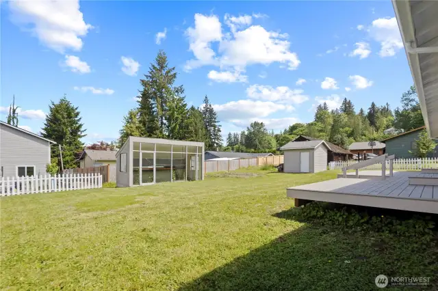 Sunny Level backyard with Greenhouse, Garden Space and Storage Shed