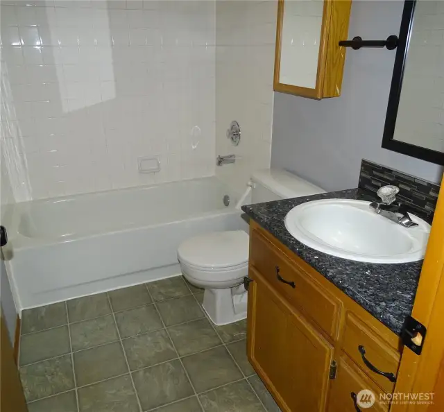 Primary Bath With Granite Countertop.