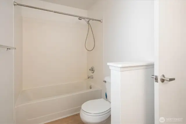 The primary bathroom is bright with new paint and new flooring.