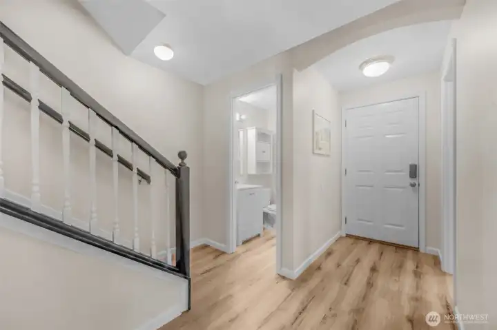 Stairs, main floor half bath and entry way