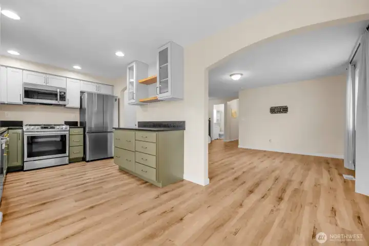 Open kitchen with updated appliances and counters