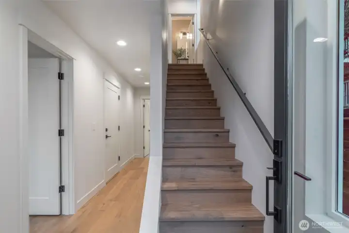 Photo is of unit 6510. Entryway + stairwell. Garage, bedroom, and a full size bathroom + closet make up the lower floor.