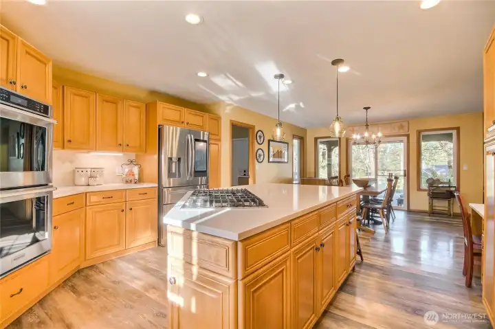 Thoughtfully designed kitchen with pull-out cabinets, under-cabinet lighting, and a large center island with built-in storage