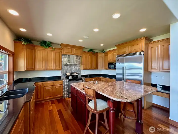 Granite countertops and stainless steel appliances complete the gourmet kitchen.