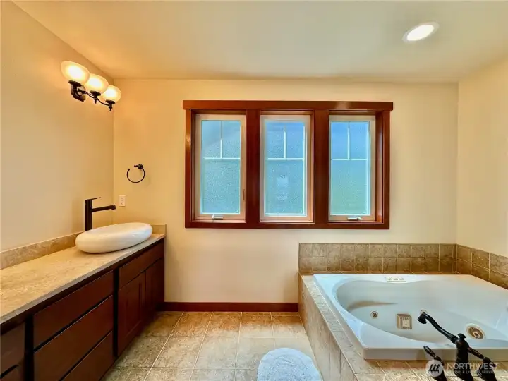 Double sinks, jetted tub and shower complete the 5-piece ensuite.