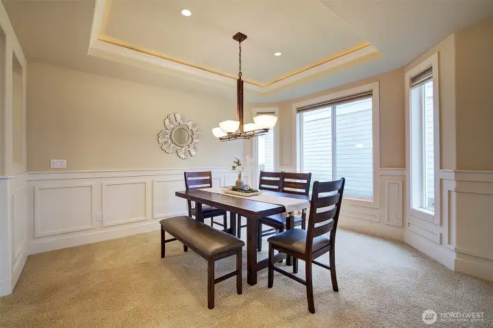 Light-filled formal dining room designed for comfortable entertaining.