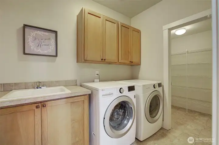 Spacious laundry room downstairs off of kitchen and large pantry.