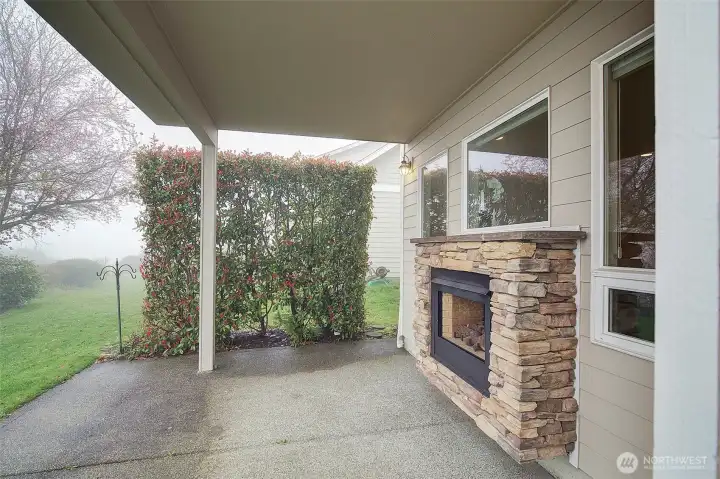 Fireplace on back patio off of kitchen.