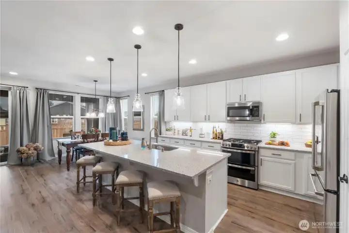 Must see to appreciate this stand-our kitchen, full of upgrades and improvements in every inch. Pull-out shelves EVERYWHERE, cabinet-height backsplash, double-oven and so many other purchase upgrades COMBINED with seller improvements even AFTER purchase.