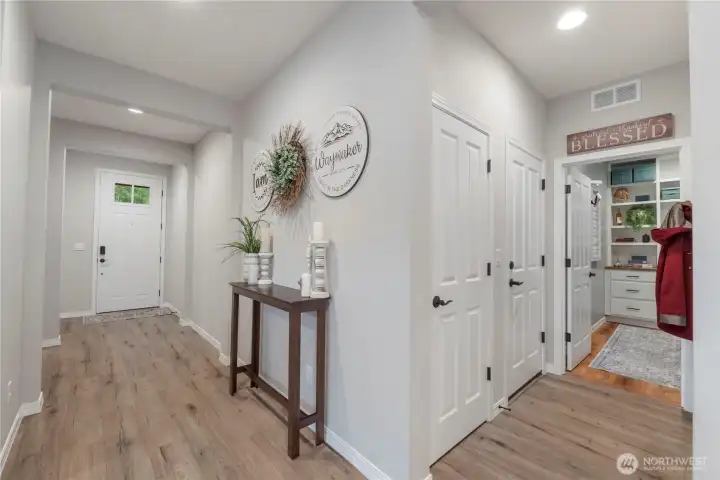 Beautiful entry presents even MORE upgrades and improvements. Window'ed door with a security peep hole, wood-wrap finishes and baseboards, seller-improved closets and that beautiful room to the right is a LAUNDRY ROOM customized for flair and function, both.