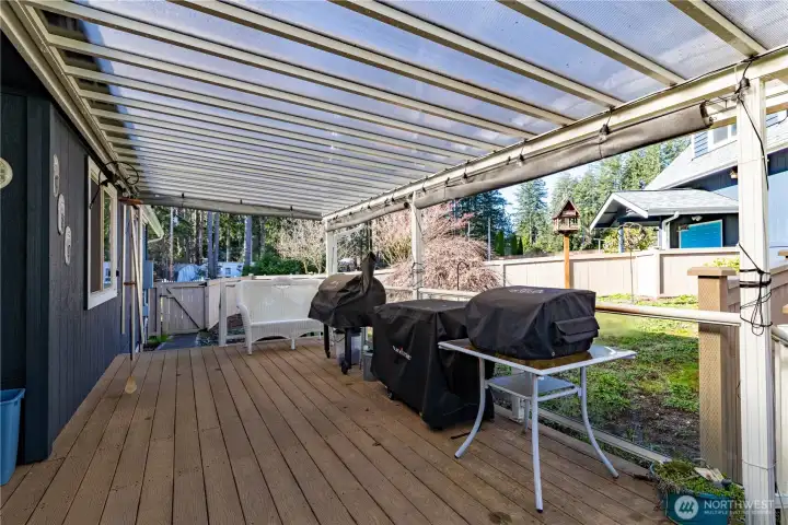 Great covered deck overlooking a fenced in area leading to the detached garage.