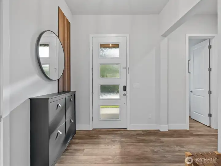 Spacious entry with a dedicated coat closet, powder room, and office/den right off the entry.