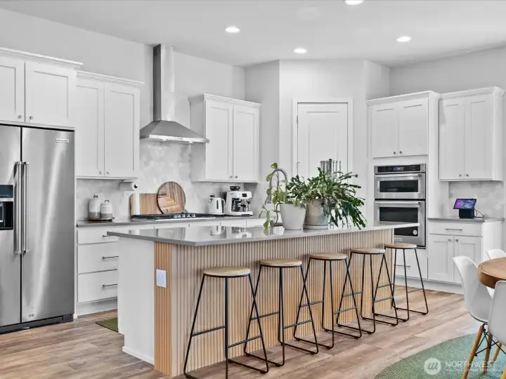 Spacious and modern kitchen features an island with seating.
