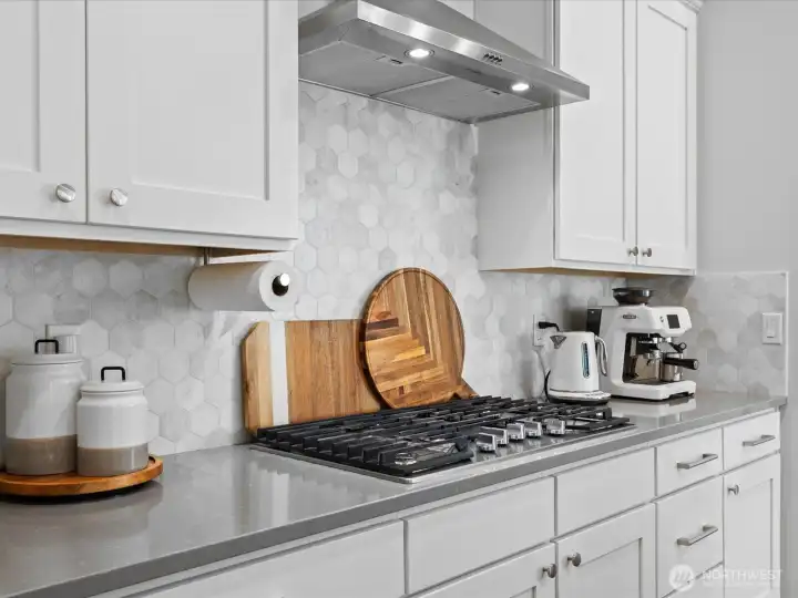 The kitchen features stainless steel appliances and a gas range.