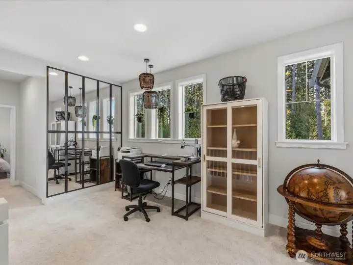 The upper level welcomes you with a loft featuring a mirror walk and currently set as an office space. There is private office/den on the main floor as well.