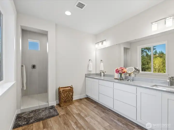 Primary bathroom is full of natural light and features a vanity with double sinks. Walk-in closet is located next to the primary bathroom.