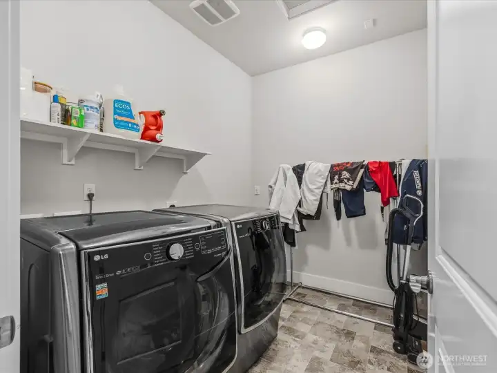 Laundry room is conveniently located on the upper level near the bedrooms.