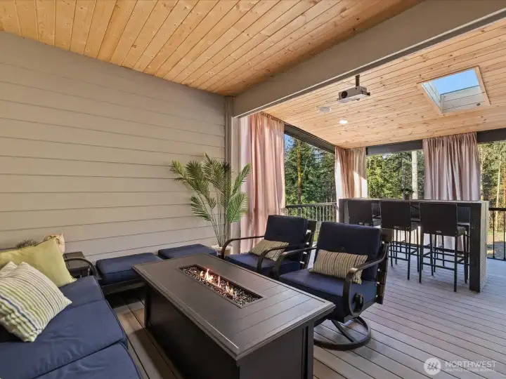 The ground-level patio features a custom-built covered area with skylights and lighting for year-round enjoyment.