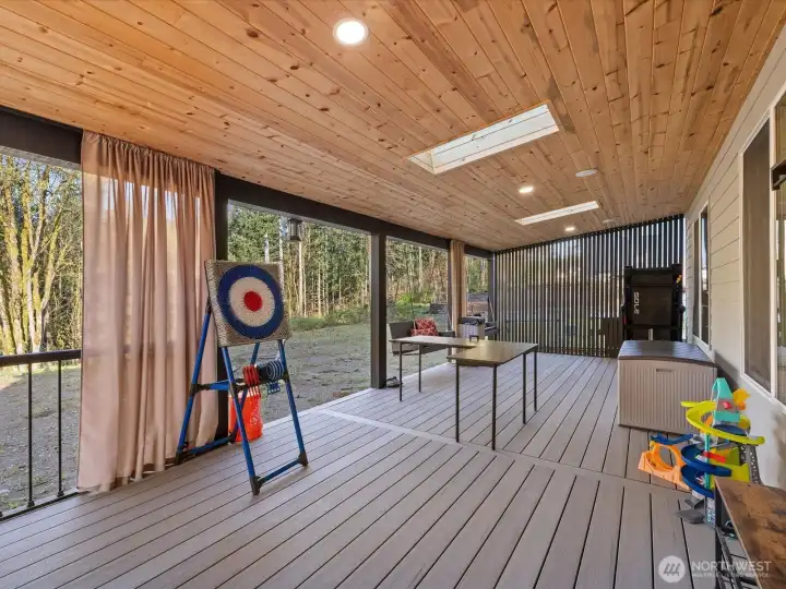 The covered patio is spacious and provides year-round enjoyment.