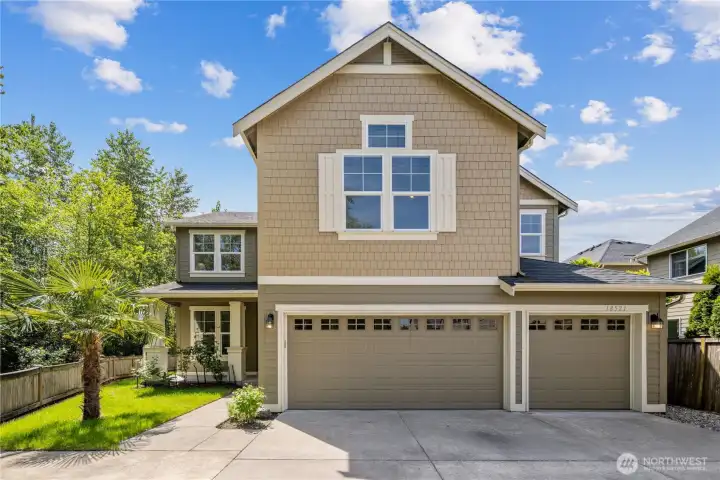 Classic Craftsman-style architecture welcomes you with handsome shutters, layered rooflines, covered entry details, and warm curb appeal. The exterior was repainted in 2020, giving the home a fresh, well-cared-for look, while the attached 3-car garage with top glass panel windows offers generous everyday parking, storage, and flexibility. Bridgeport light fixtures add a touch of style.