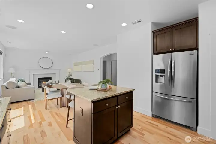 The stainless steel French-door refrigerator keeps the kitchen feeling polished and easy to use, with ice and water right in the door and a bottom freezer tucked below. Fresh foods stay up where you can see and reach them, so there's no bending down for the everyday fridge items you use most. From here, the kitchen stays connected to the dining nook and family room, so snacks, drinks, and conversation all stay close.