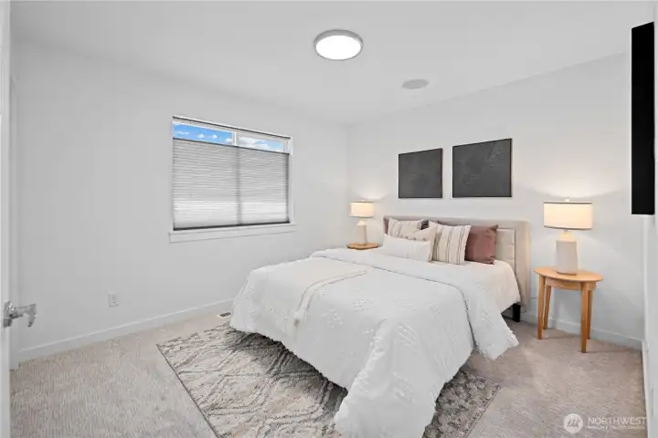 The second upstairs guest bedroom continues the same clean, refreshed feel, with new carpet, fresh paint in the home’s bright cohesive color, and generous space for sleeping, studying, or settling in. A large south facing window with blinds brings in natural light all day, a large closet keeps storage close, and the new round flush-mount ceiling light spreads an easy, even glow. The built-in whole-house speaker system carries music through the home.