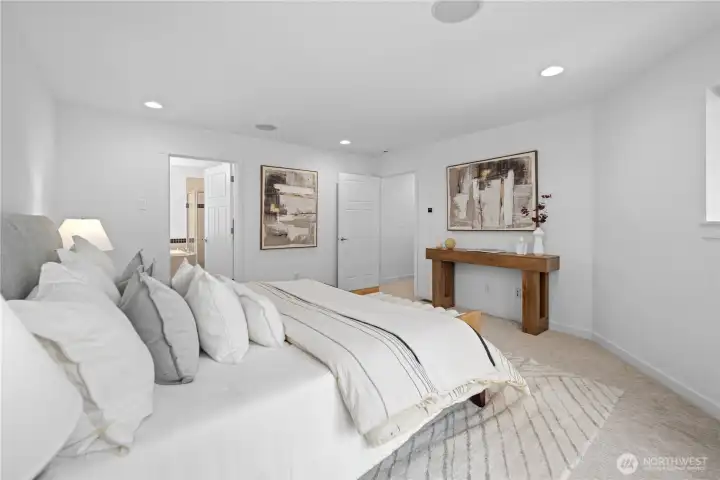 Generous proportions and a high ceiling give the primary bedroom a spacious, peaceful presence, with new carpet adding softness underfoot. The private bath and huge walk-in closet beyond complete the suite, creating a comfortable retreat set quietly apart within the home.