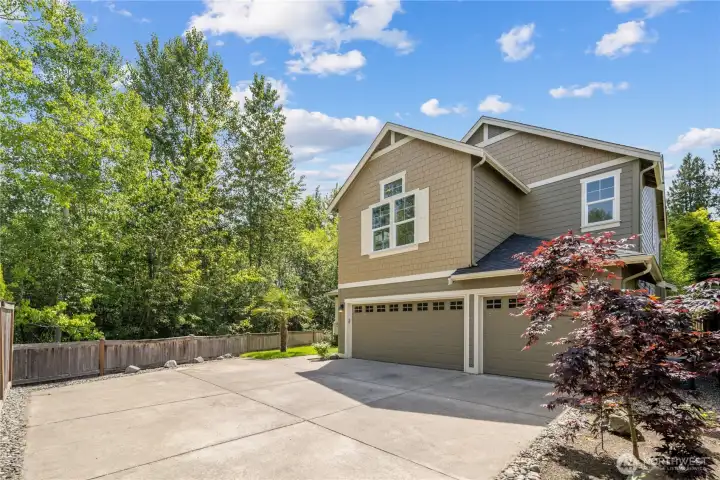 The expansive driveway gives the home extra room for additional parking, guest vehicles, or everyday comings and goings with ease. A hot and cold water spigot next to the garage makes outdoor tasks more convenient, from washing cars to rinsing tools, planters, or patio items after time outside.