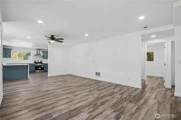 Dining area and views into kitchen , bedroom 2 off to the right and stairway entrance.